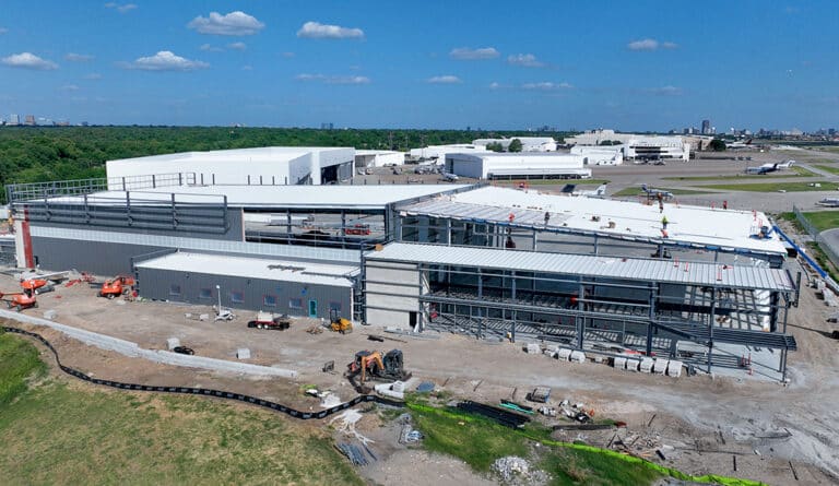 Two connected hangars in the midst of construction at Dallas Love Field