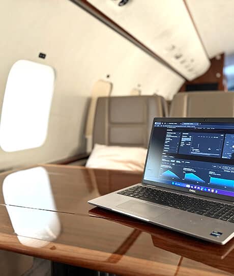 starlink photo portal_mobilebackg An open laptop on the table of a private jet showing a connectivity portal for the aircraft