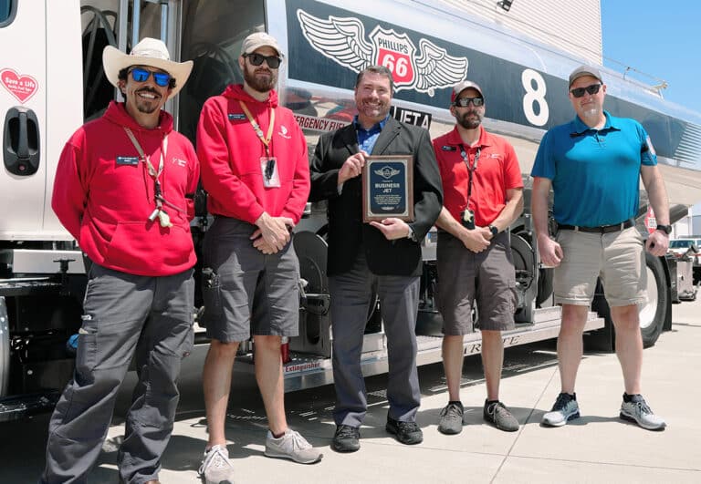 Business Jet team members standing next to Phillips 66 Jet Fuel Truck holding Safe Sky Award.