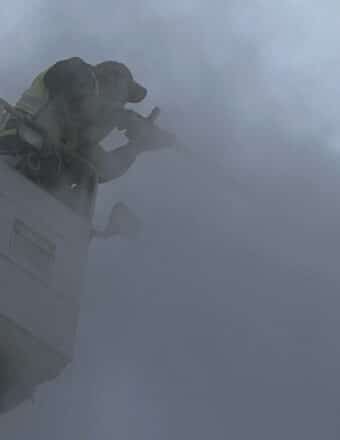 Man performing de-ice procedure on an aircraft wing before takeoff.