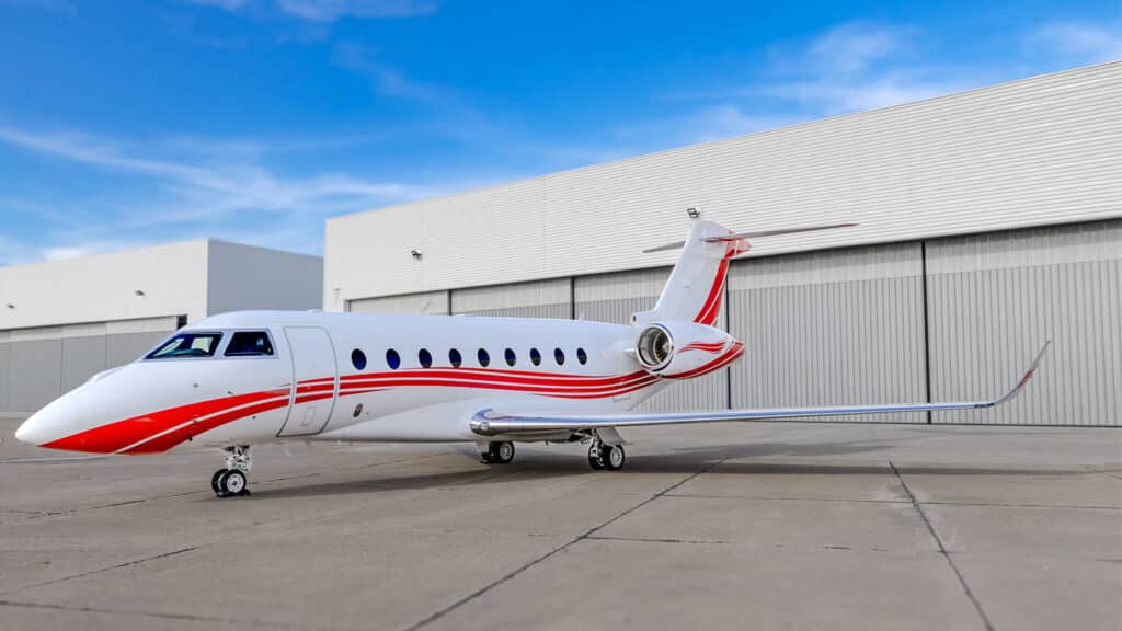 Exterior of a sleek Gulfstream G280 with red stripes