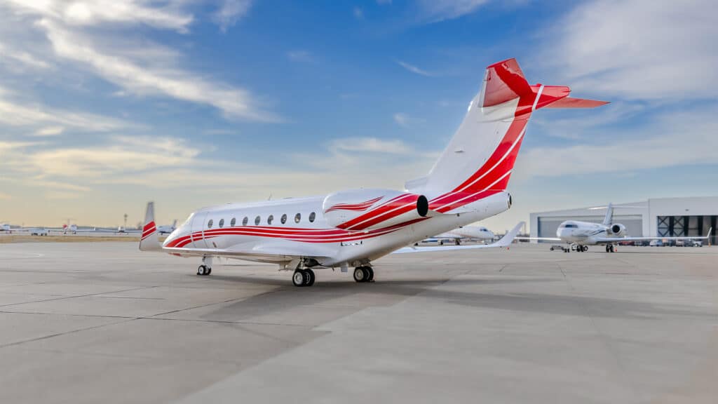 Exterior tail view of a Gulfstream G280 with multiple aircraft in the background.