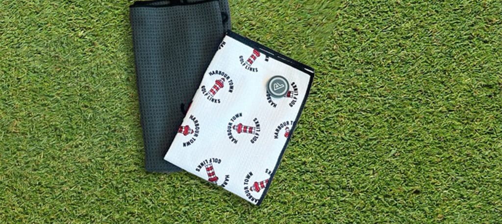 A Caddy towel laid on the golf green