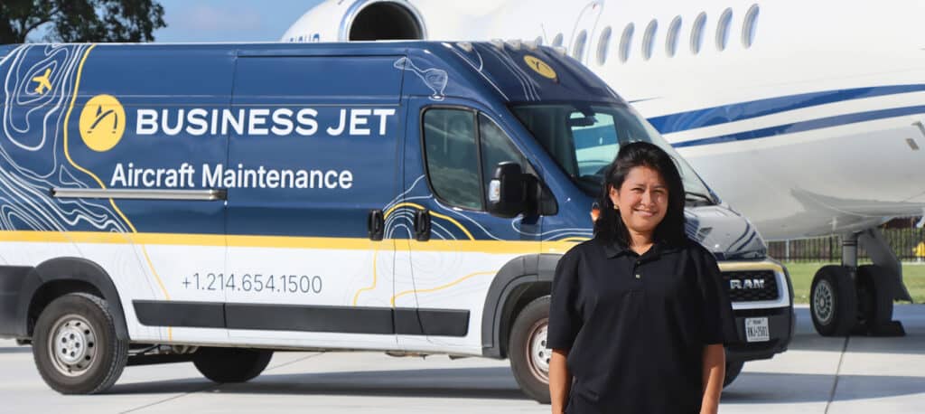 Private Aviation AOG Technician standing in front of an AOG van and Falcon 900EX
