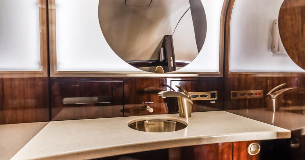 Private enclosed lavatory sink aboard a private jet.